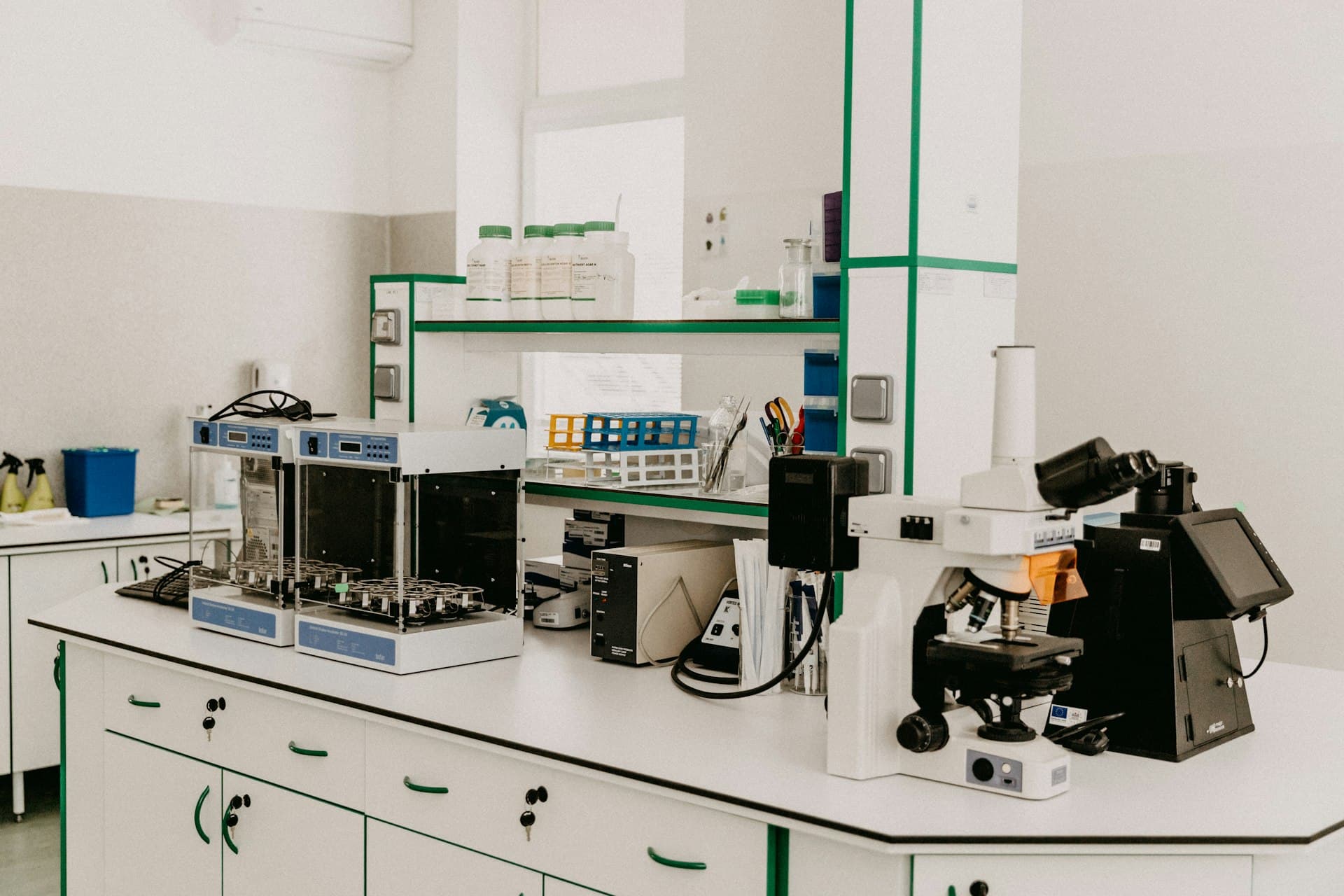 A laboratory bench with a microscope and test equipment.