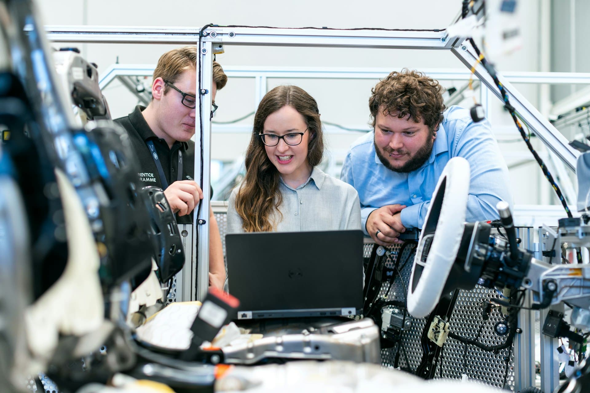 Engineers reviewing test results together around a laptop.